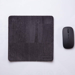 Black travel mousepad with wireless mouse next to it