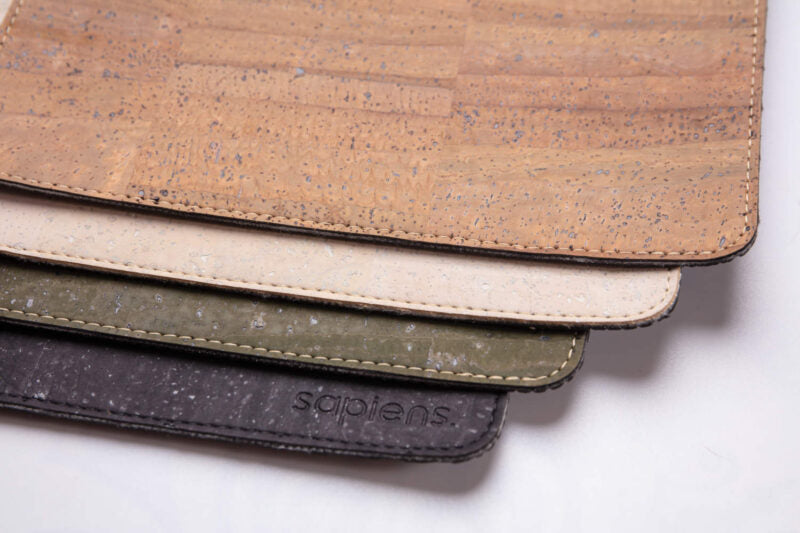 Multiple colors of cork leather laptop pads overlayed on top of one another