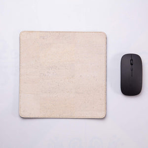 White travel mousepad with wireless mouse next to it