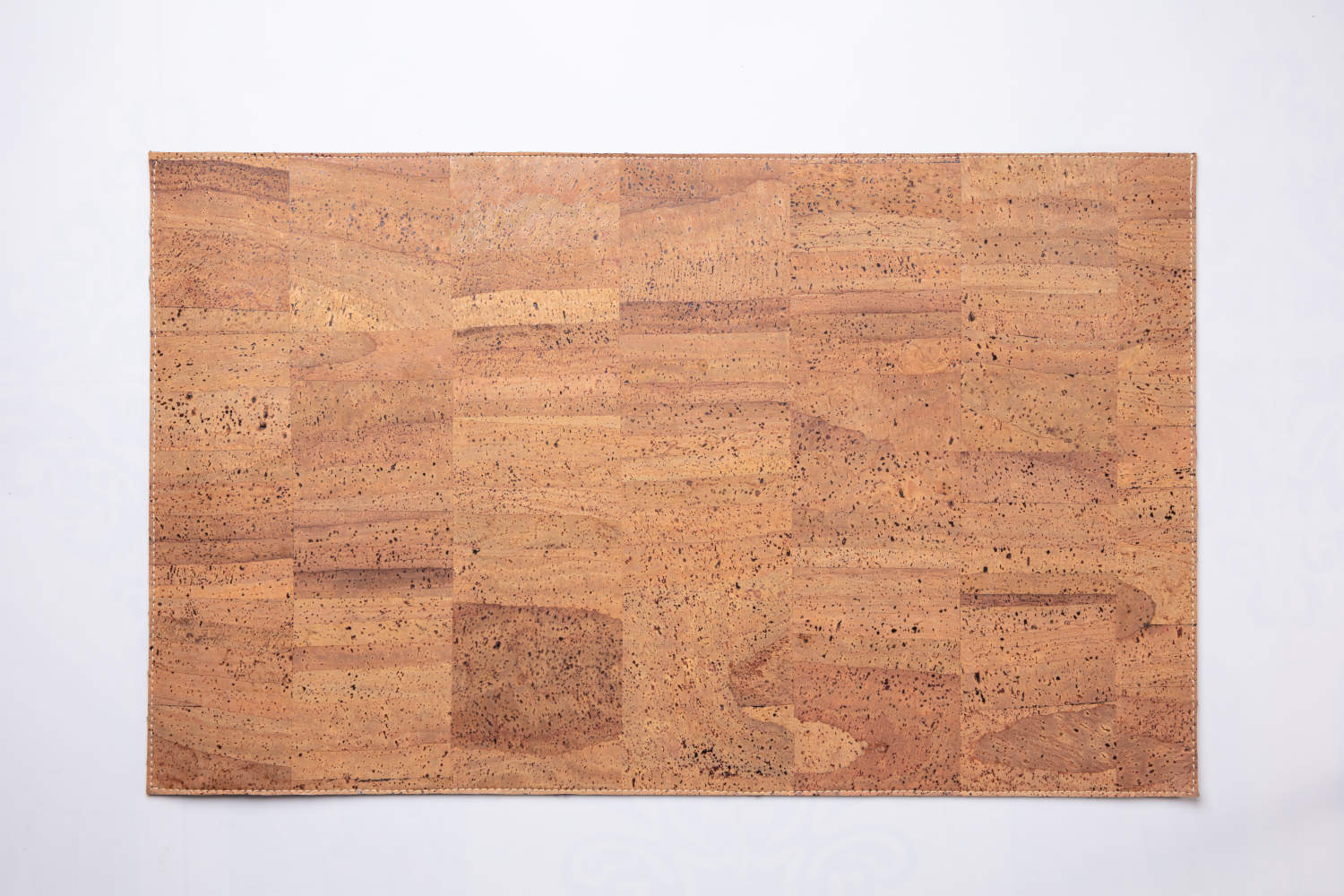 Overhead view of tan cork leather laptop desk pad