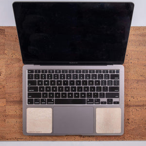 Overhead view of 13-inch Macbook on tan cork leather laptop desk pad